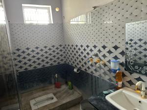 a bathroom with a shower and a sink at Vardan Homes in Mathura