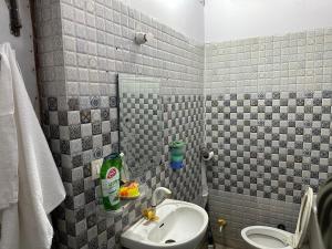 a bathroom with a sink and a toilet at Vardan Homes in Mathura