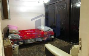a small bedroom with a bed with a red blanket at BLUE Wave in Alexandria
