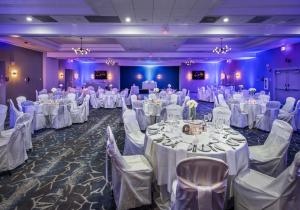 a banquet hall with white tables and chairs at DoubleTree by Hilton Monroe Township Cranbury in Rossmoor