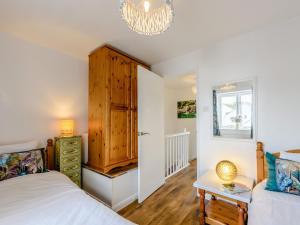 a bedroom with a bed and a chandelier at 2 Bed in Bideford 79441 in Bideford