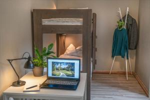 a desk with a laptop and a bunk bed at Göteborgs Bed & Breakfast in Gothenburg