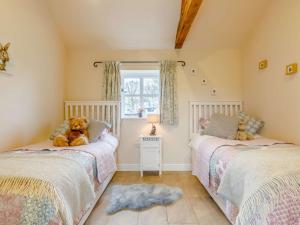 two beds in a room with two teddy bears on them at 2 Bed in Audlem 81106 in Audlem