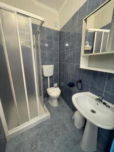 a bathroom with a shower and a toilet and a sink at West Coast Peniche in Peniche