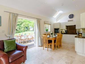 a kitchen and living room with a table and chairs at 3 Bed in Chester 82909 in Ledsham