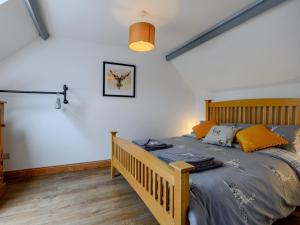 a bedroom with a wooden bed in a room at 2 Bed in Rothbury 83597 in Rothbury
