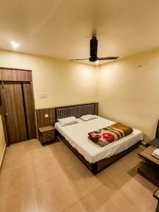 a bedroom with a bed in a room at Ambassador Hotel in Guwahati