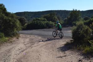 a man riding a bike on a dirt road at Apartamentos El Prado in Valbona +33 photos