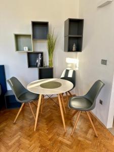 a table and four chairs in a room at Modern studio in the heart of the city in Maribor