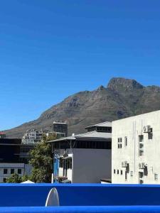 a view of a building with a mountain in the background at Modern city townhouse with rooftop terrace in Cape Town