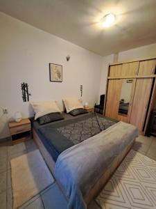 a bedroom with a large bed in a room at Apartman Vitas in Slavonski Brod