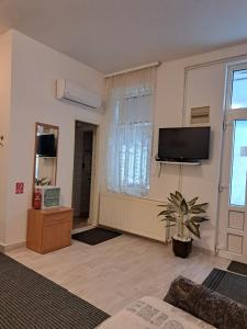 a living room with a flat screen tv on the wall at Apartman Vitas in Slavonski Brod