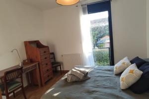 a bedroom with a bed and a desk and a window at Nature Montagn view Salève Geneva - 12 pers. 2 logements in Beaumont