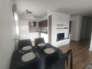 a black table and chairs in a living room at Nature Montagn view Salève Geneva - 12 pers. 2 logements in Beaumont