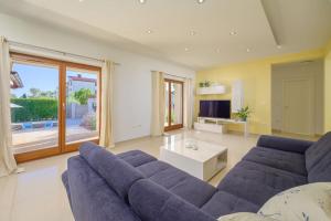 a living room with a blue couch and a tv at Villa Lana by IstriaLux in Vodnjan