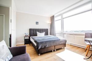 a bedroom with a bed and a large window at App. Busch 45 in Westerland (Sylt)