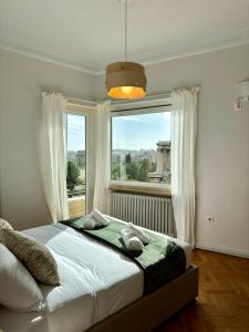 a bedroom with a bed and a large window at Niki in Athens in Athens