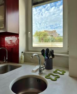 a kitchen counter with a sink and a window at Niki in Athens in Athens