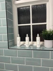 a window with three soap bottles on a window sill at 4 Mellors Court in Warwick