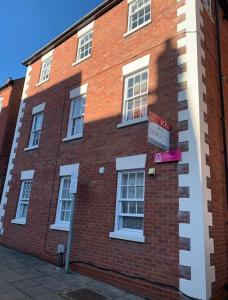 a brick building with a sign on the side of it at 4 Mellors Court in Warwick