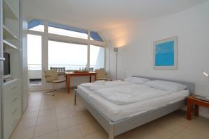 ein Schlafzimmer mit einem Bett und einem Tisch und einem Fenster in der Unterkunft Haus am Meer14 - App. 159 in Westerland
