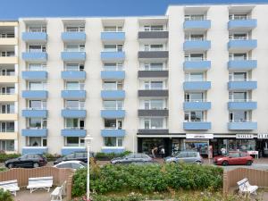 a large white building with blue balconies at App. Kohfahl 65 in Westerland