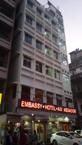a tall building with a hotel sign in front of it at Ambassador Hotel in Guwahati
