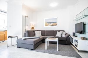 a living room with a couch and a tv at App. Hegger Inselglück in Westerland (Sylt)