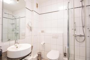 a bathroom with a sink and a shower and a toilet at App. Hegger Inselglück in Westerland (Sylt) +13 photos