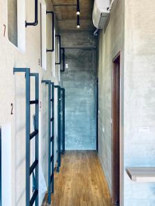 a hallway with a row of glass racks on the wall at Sasa Youth Hostel in Jiaoxi
