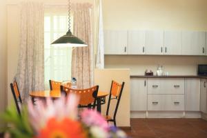 a kitchen and dining room with a table and chairs at Oak lodge Guest House in Grahamstown