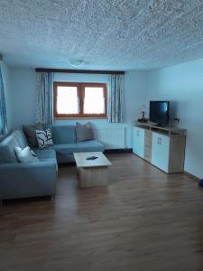 ein Wohnzimmer mit einem Sofa und einem Couchtisch in der Unterkunft Ferienhof Bichlhof in Arzl im Pitztal