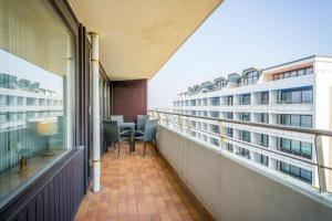 a balcony of a building with a table and chairs at Haus Metropol 175 OB in Westerland (Sylt)