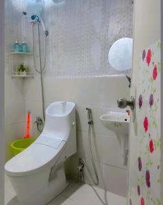 a bathroom with a toilet and a sink at 1-BR Condo Unit Urban Deca Homes Manila in Manila