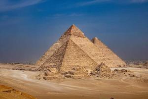 an image of the pyramids in the desert at Golden pyramids view in Cairo