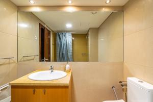 a bathroom with a sink and a mirror at Akisol Troia Pearl in Troia