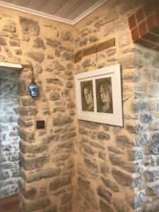 a stone wall with a picture on it at Benny's Beach House in Encounter Bay