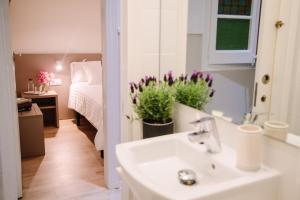 łazienka z umywalką oraz sypialnia z łóżkiem w obiekcie Hostalet de Barcelona w Barcelonie