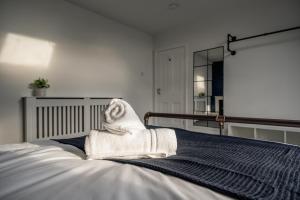 a white towel sitting on top of a bed at Grange House by Horizon Stays in Hartlepool