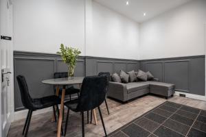 a living room with a couch and a table and chairs at Grange House by Horizon Stays in Hartlepool