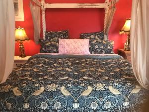 a bedroom with a large bed with red walls at Benny's Beach House in Encounter Bay