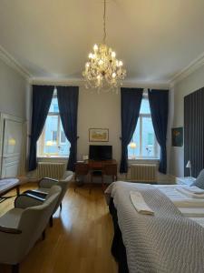 a bedroom with two beds and a chandelier at Lilla Hotellet in Sundsvall