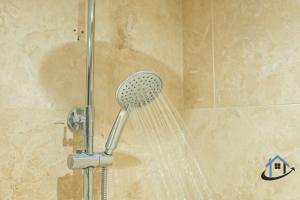 a shower with a shower head in a bathroom at Stanwick Studio, cosy country studio, sleeps 4, parking, wifi in Stanwick