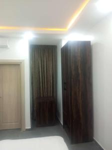 a room with two large wooden doors and a room with at Skenyo Hotel & Apartments in Ketti