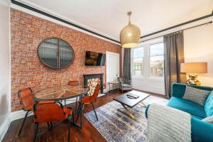 a living room with a brick wall at Central Apartment - Industrial in Blairgowrie