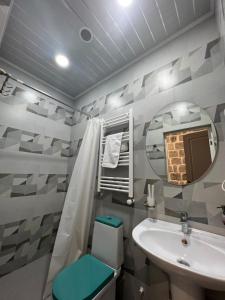 a bathroom with a sink and a toilet and a mirror at JINJOTEL Gyumri in Gyumri