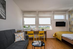 a living room with a couch and a table at Starter 24 Wrocław in Wrocław