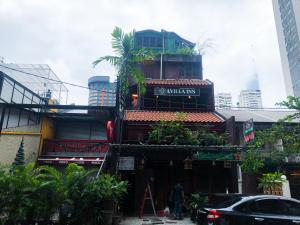 a man standing in front of a building at OYO 90909 I.villa Inn in Kuala Lumpur