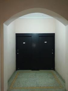 un garage avec deux portes noires dans une pièce dans l'établissement PARK VIEW PALACE,Bhubaneswar, à Bhubaneswar