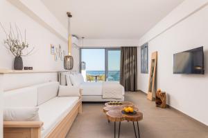 un soggiorno con divano e tavolo di 8MOONS Elegant Apartments a Kokkari